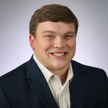 John Barron Johnson's headshot on a gray background