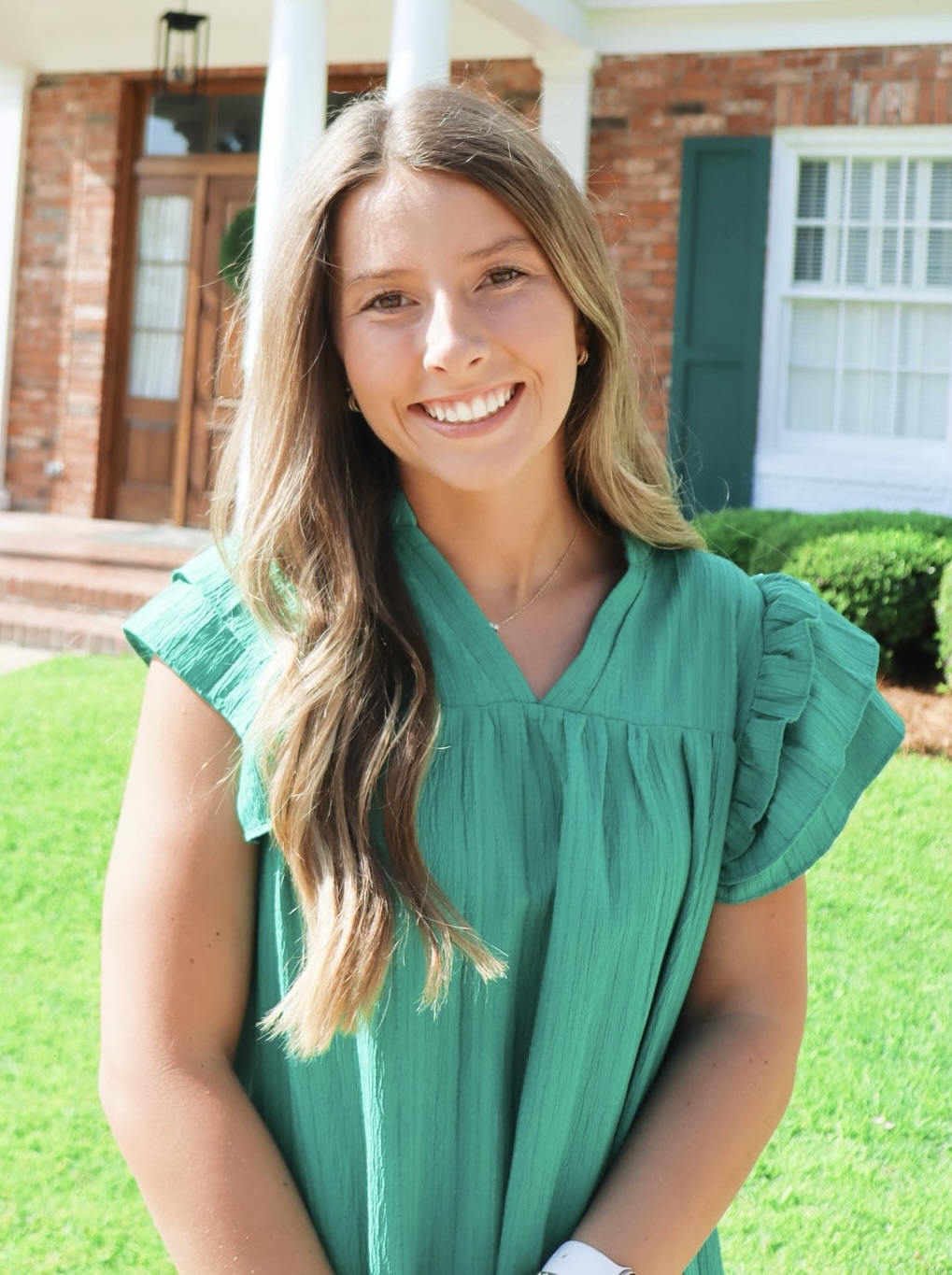 Ali Martin wearing a green top outside 