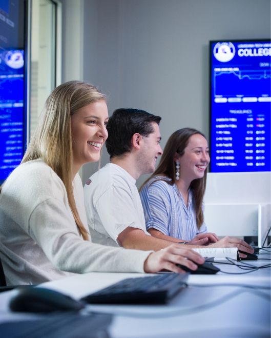 Two females and one male students in a computer lab