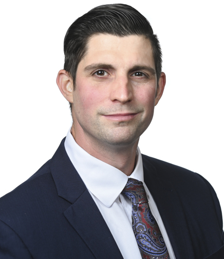 Headshot of Justin Kavalir on a white background