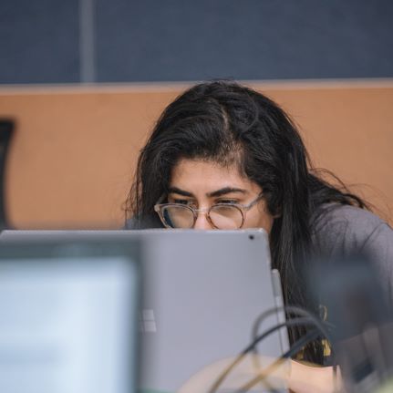 Student working behind a laptop