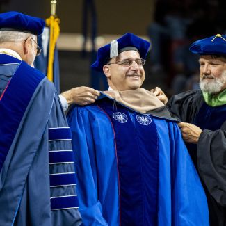 Student getting hooded at Commencement