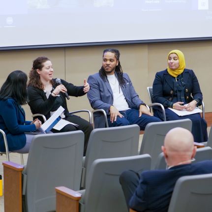A group of panelists are talking to the audience about technology inside and outside the classroom