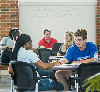 Business students hanging out in the Benjamin Denny Student Commons.