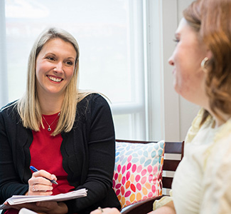 A student visits with staff.