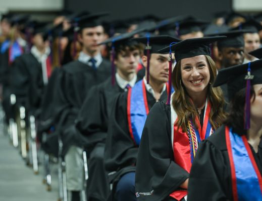 Students at Louisiana Tech graduation with the focus on a female graduate