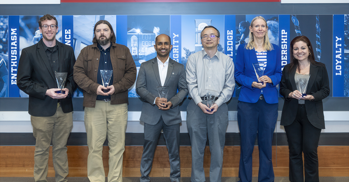 Six Louisiana Tech faculty stand with their research awards
