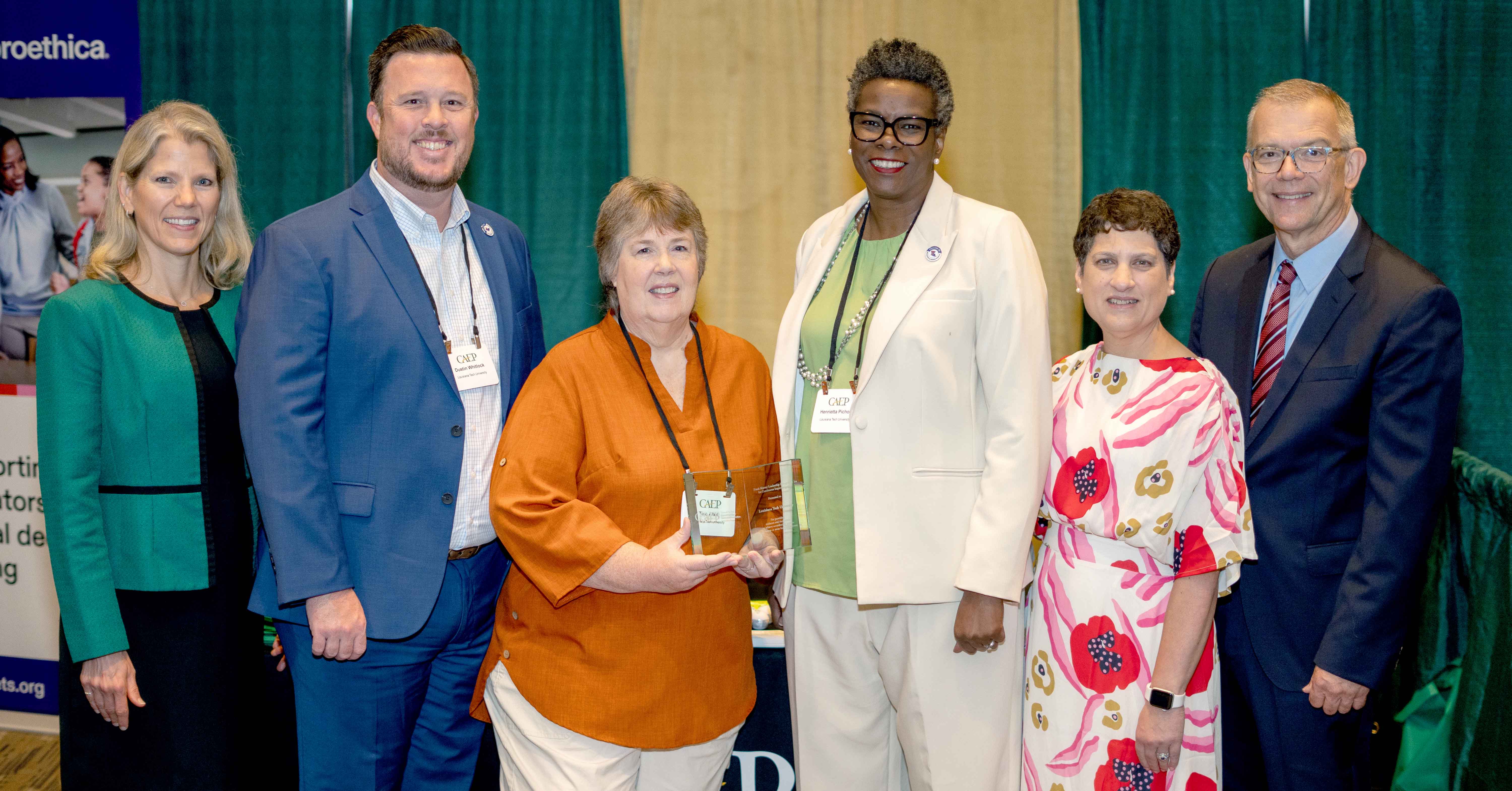 Three Louisiana Tech faculty members stand alongside members of the CAEP Executive Leadership Team.
