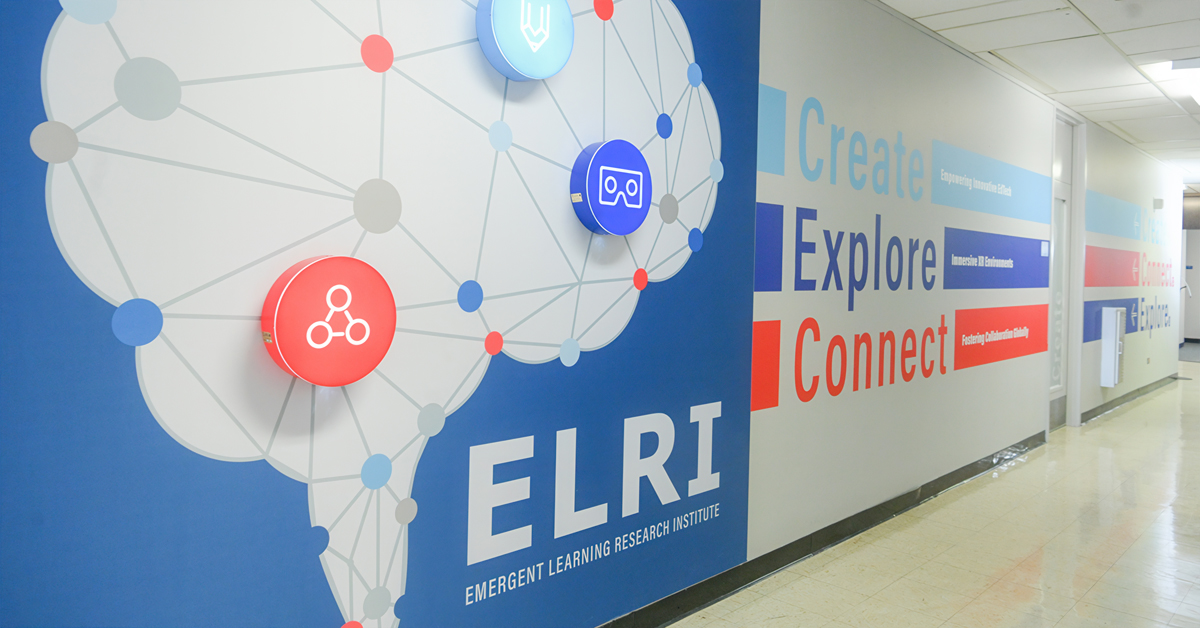 "Create, Explore, Connect" wall art in a hallway