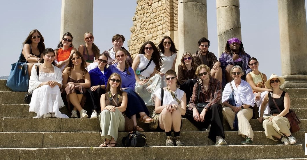 Louisiana Tech students sit together on steps in Volubilis, Morocco