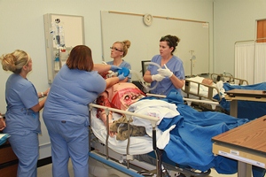 Louisiana Tech nursing students work on a "patient" badly burned in a meth lab explosion at the Nursing Division's new simulation lab in George T. Madison Hall.