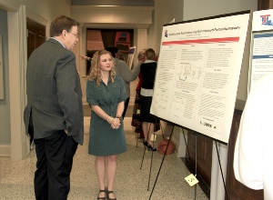 Senior Biomedical Engineering major Rachel Baker shows her Quantifying Space-Related Edema using Multi-Wavelength Photoplethysmography poster presentation to Louisiana Tech University President-Elect Dr. Les Guice during Thursday's 2013 Tech Undergraduate/Graduate Student Research Symposium held at University Hall.