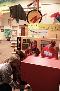 SciTEC workers, left to right, Laura Murphy, Katy Rivera, Tammy Nugent and Ginger Ray explore one of the exhibits donated from OMSI.