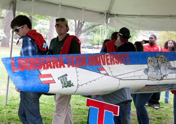 High students attending Louisiana Tech's Engineering and Science Day work with a concrete canoe built by Tech students.