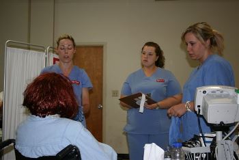 Nursing students at Louisiana Tech care for a domestic violence 'victim' during a simulation exercise.