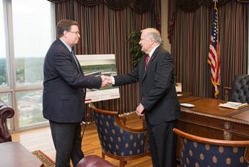 In his last official act as Louisiana Tech President, Dr. Dan Reneau (right) passes keys to his office to incoming President Les Guice