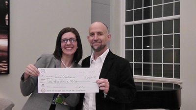 Alicia Boudreaux (left) receives cash prize from Louisiana Tech Chief Innovation Office r Dr. Dave Norris.