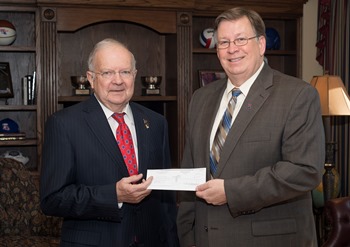 Louisiana Tech President Les Guice (right) is joined by President Emeritus Dan Reneau to receive a $920,000 gift from the Patrick F. Taylor Foundation.