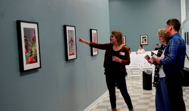 Visitors peruse digital artwork created by Louisiana Tech students during an exhibit and auction at the Enterprise Center.