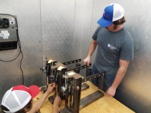 John and Jeb Kraft work on a project to measure long-term tensile creep data.