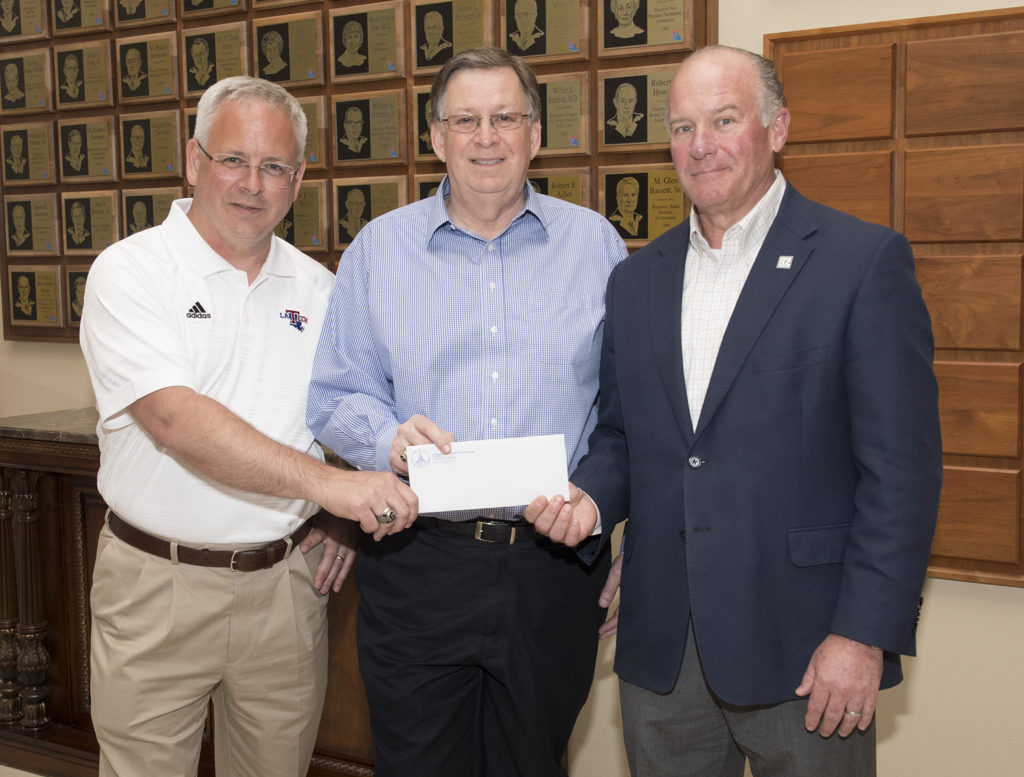 University of Louisiana System President and CEO Dr. Jim Henderson and Louisiana Tech President Dr. Les Guice accept funds from Louisiana Tech University Foundation Board President Bill Hogan. Donations toward the University Excellence Fund are being used to assist faculty and staff members who suffered catastrophic losses during the April 25 tornado.