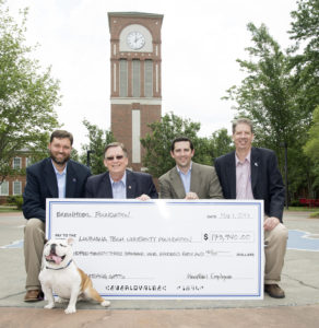 Dr. Heath Tims, Dr. Les Guice, and Dr. Hisham Hegab accept ExxonMobil's donation from 1999 graduate Troy O’Laughlin.