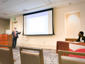 Sam Dinnat presents his original research titled "What portion of the volatility of the interest rate can be attributed to excess reserve policy? Does including this relationship as an exogenous variable make other macroeconomic forecasts better?" at the Economic Scholars Program (ESP) at the Federal Reserve Bank of Dallas.