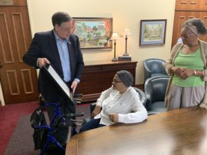 Dr. Guice presents Cee Cee with her proclamation, Cee Cee's daughter and classmate Jon Jon Givens looks on