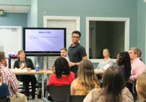 A student makes a pitch for his business idea to the crowd.