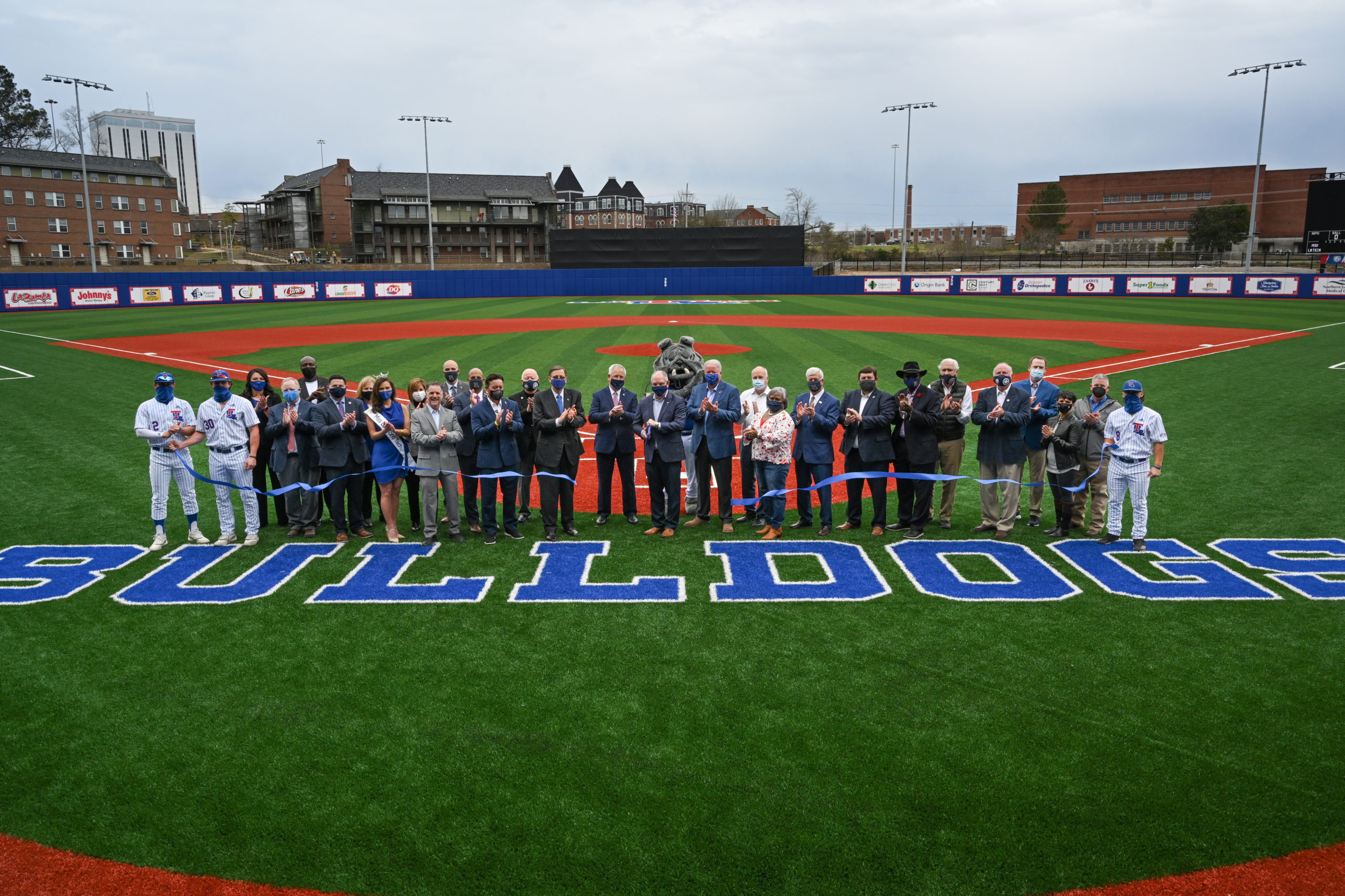 Excited staff, legislators, athletes and donors gather on J.C. Love Field at Pat Patterson Park for a ribbon cutting ceremony to celebrate the completion of Louisiana Tech University’s Origin Bank Baseball Complex.