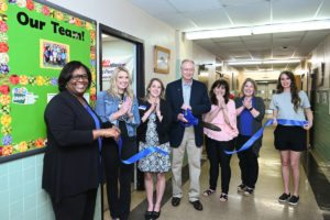 ANS representatives cut the ribbon on the food pantry