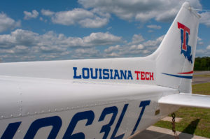 plane's tail decorated with the Louisiana Tech logo