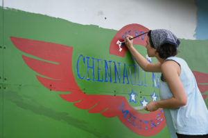 A student works on the Chennault mural