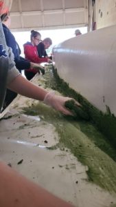 Students work together to create a concrete caneo