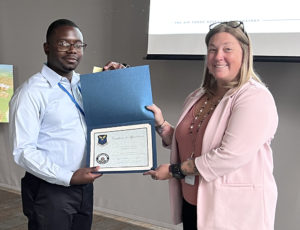 Tim Oliver, Louisiana Tech University CIS student, is recognized by Cyber Innovation Center Project Manager Melissa Nyman for his work in the AFRL Scholars program. The AFRL Scholars Program at Barksdale Air Force Base, Louisiana, offers various technical projects in STEM fields that will enhance AFGSC’s data collection and analytics. (Sean Green/STRIKEWERX)