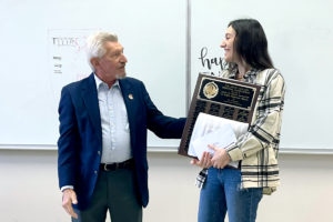 John Lee presents Anna Graney with scholarship award.